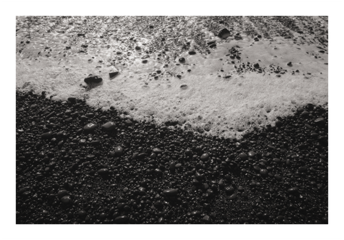 Fine art photography print of frozen ocean waves on Iceland volcanic coast, Hahnemühle Photo Rag paper